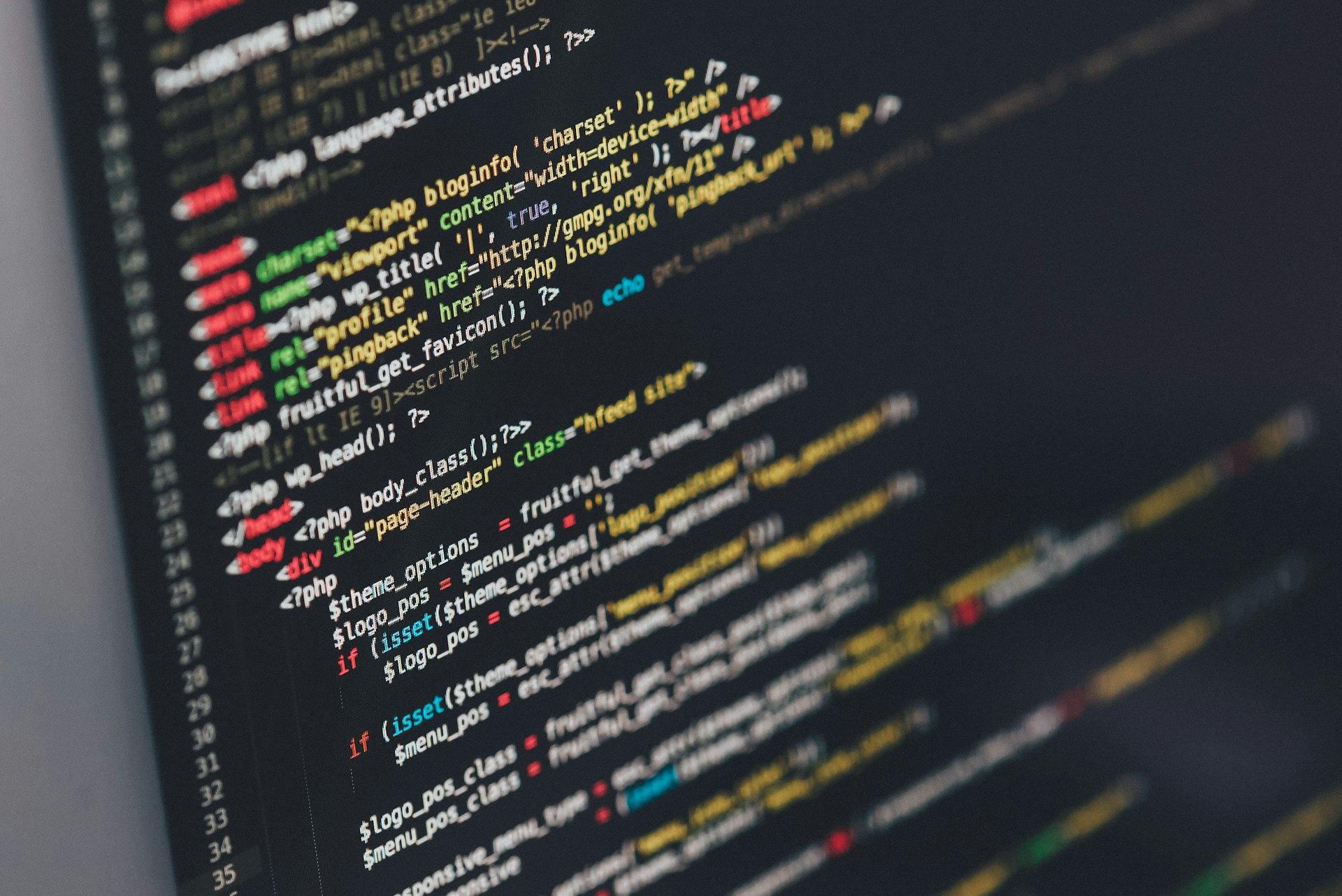 Developer writing code on multiple monitors in a modern Indian SaaS team workspace